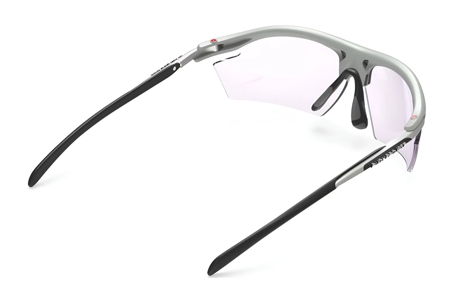Rudy Project Rydon Sunglasses by Rudy Project shown from the back at an angle on a white background, featuring a silver and black frame, clear lenses, and adjustable anti-slip nosepads. Rudy Project Rydon Sunglasses by Rudy Project shown from the back at an angle on a white background, featuring a silver and black frame, clear lenses, and adjustable anti-slip nosepads.