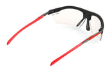 The Rudy Project Rydon Sunglasses feature red arms, a black frame, and clear lenses with adjustable anti-slip nosepads for a secure fit. Shown on a white background.